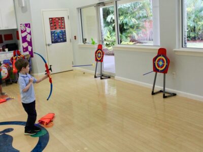 EEAE students using toy bow and arrows image