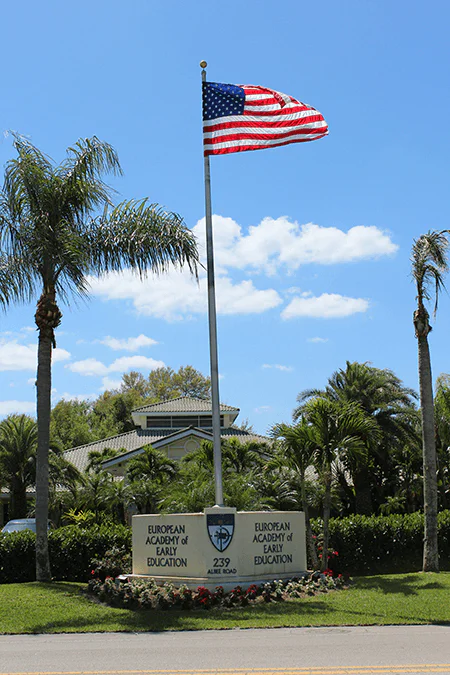 eaee-flag EEAE entrance sign with american flag image